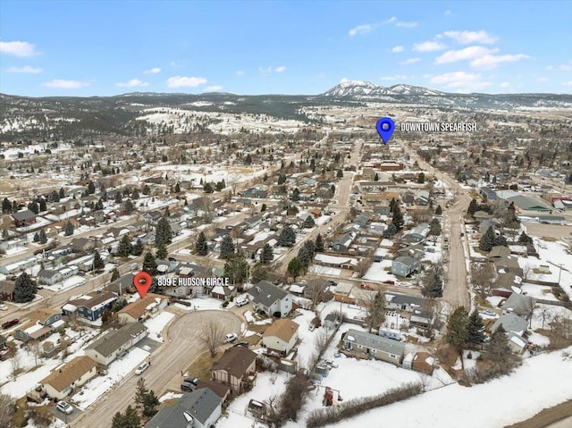 snowy aerial view featuring a mountain view