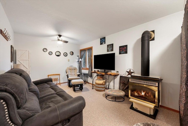 carpeted living room featuring a textured ceiling, ceiling fan, and a wood stove