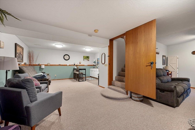 carpeted living room featuring a textured ceiling