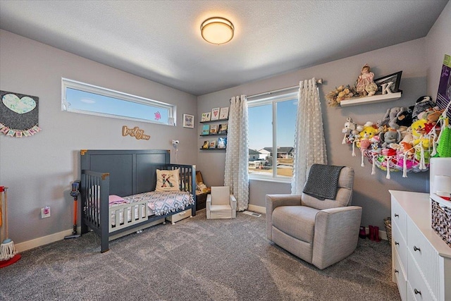 bedroom featuring dark carpet and a textured ceiling