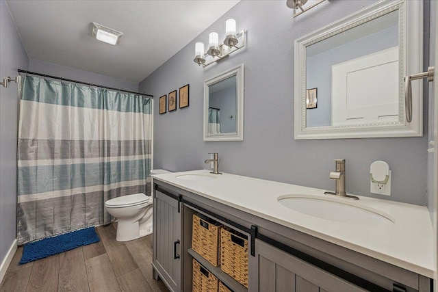 bathroom featuring vanity, hardwood / wood-style floors, and toilet