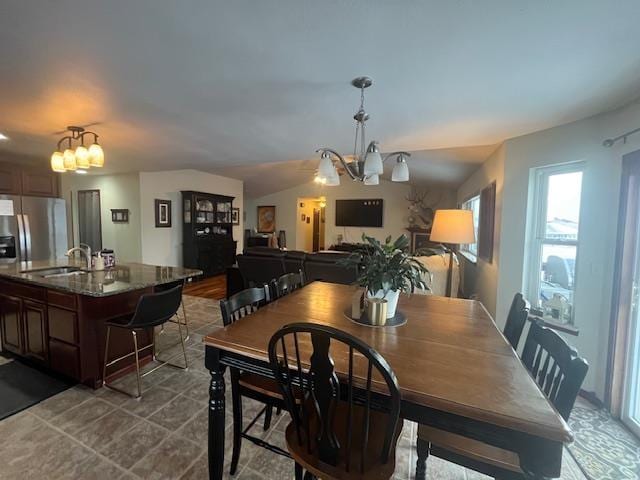 dining room featuring sink and a chandelier