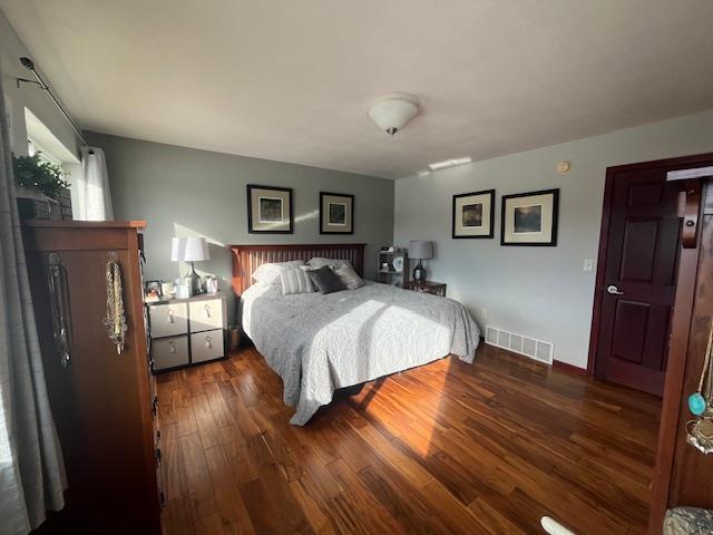 bedroom featuring dark wood-type flooring