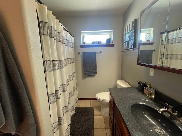 bathroom with tile patterned flooring, vanity, toilet, and a shower with shower curtain