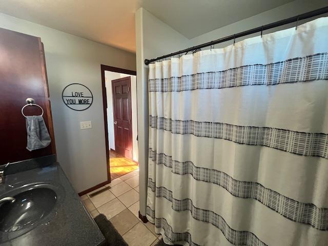 bathroom with tile patterned flooring and vanity