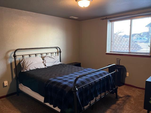 bedroom featuring dark colored carpet