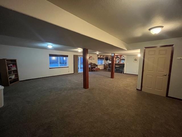 basement featuring dark colored carpet