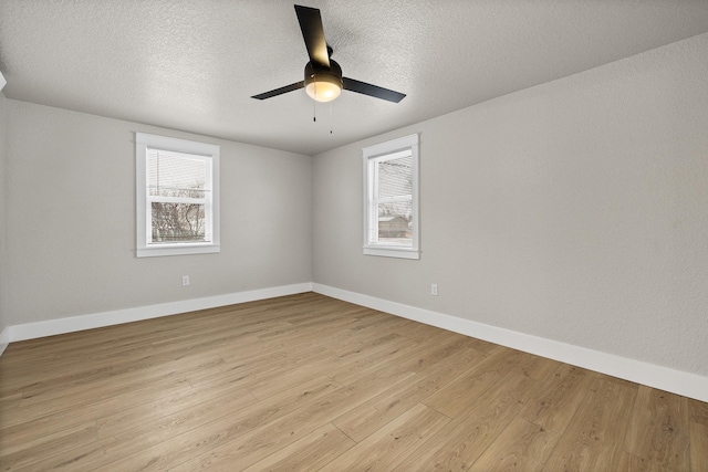 empty room featuring ceiling fan, light hardwood / wood-style floors, and a textured ceiling