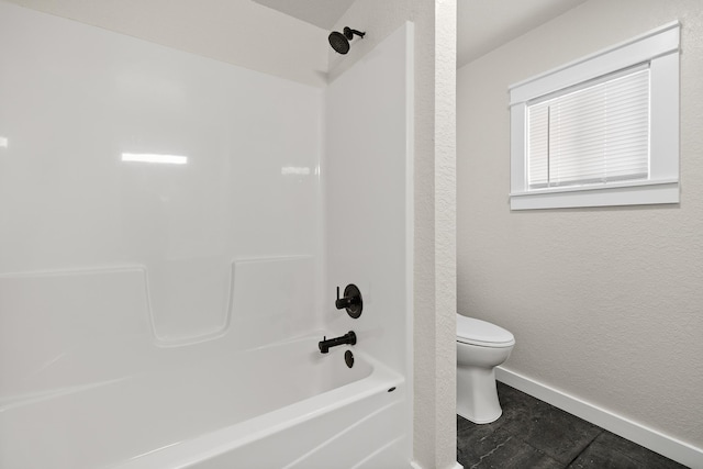 bathroom featuring shower / bathing tub combination and toilet