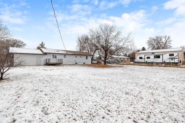 snow covered property featuring a deck