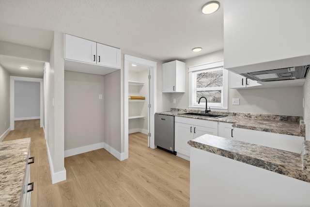 kitchen with sink, light wood-type flooring, white cabinetry, dishwasher, and a textured ceiling