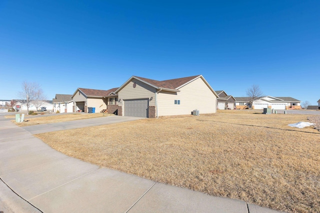 ranch-style house with a garage and a front lawn