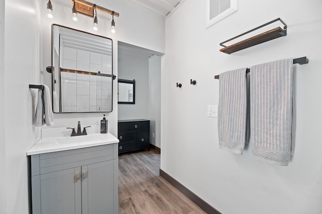 bathroom with hardwood / wood-style flooring and vanity