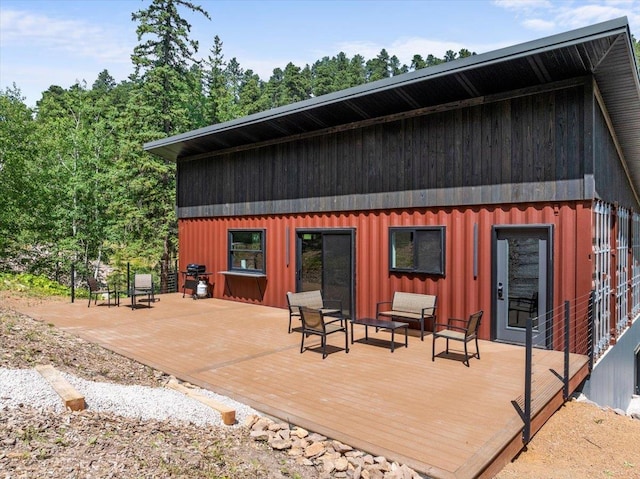 rear view of house featuring a deck