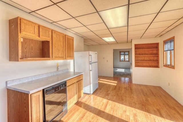 kitchen with white refrigerator, a paneled ceiling, dishwasher, and light hardwood / wood-style floors