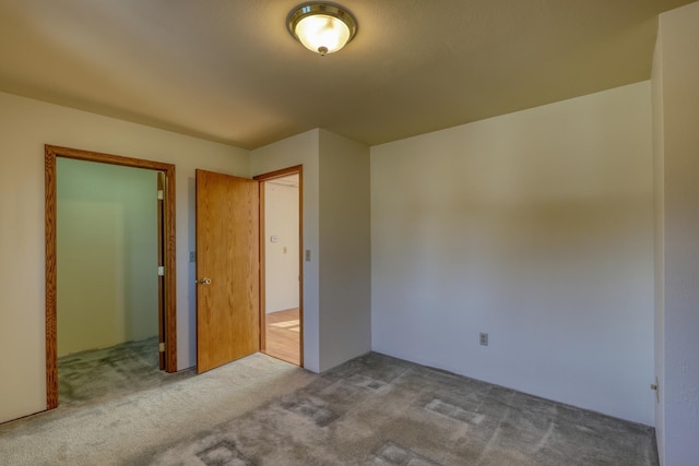 unfurnished bedroom featuring light carpet