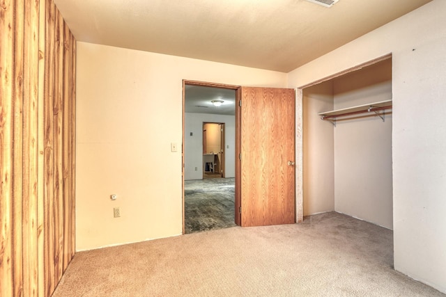 unfurnished bedroom featuring a closet and carpet