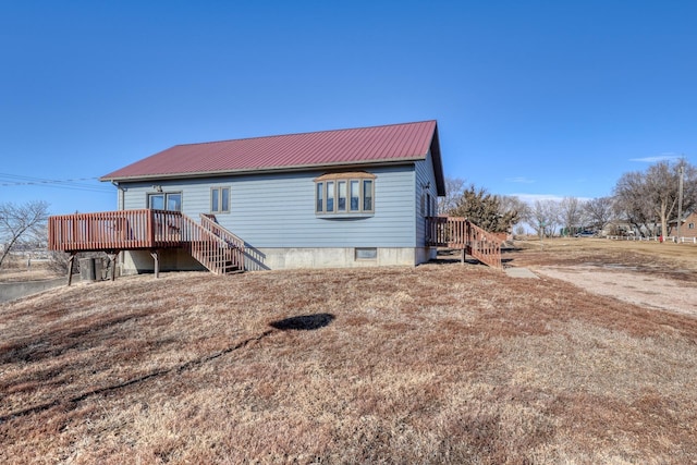 back of house featuring a deck