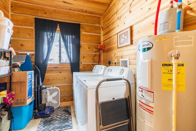 clothes washing area featuring wooden ceiling, separate washer and dryer, water heater, and wood walls