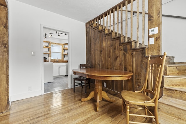 dining room featuring track lighting and light wood-type flooring