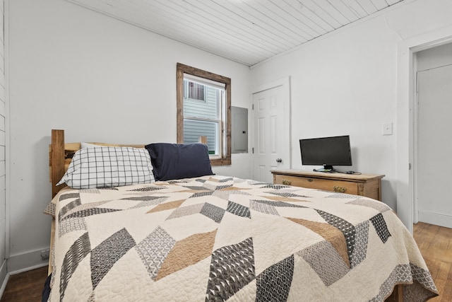 bedroom featuring hardwood / wood-style floors and electric panel