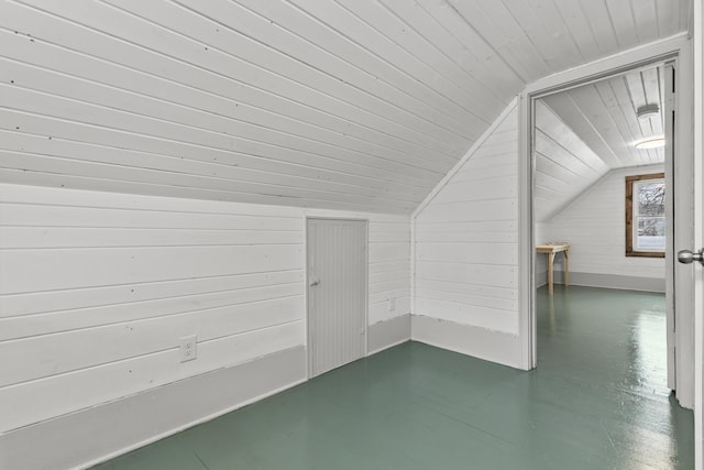 bonus room with vaulted ceiling, wood ceiling, and wood walls