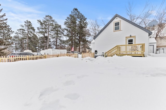 snowy yard featuring a deck