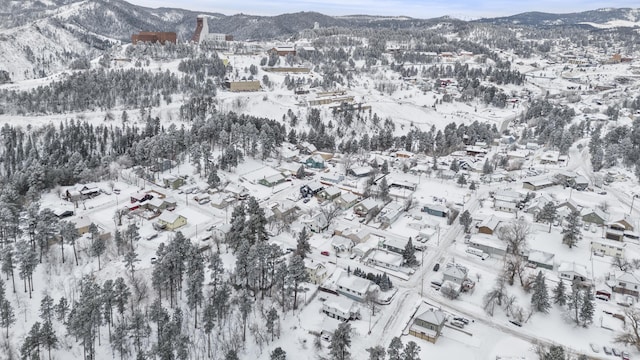 snowy aerial view featuring a mountain view