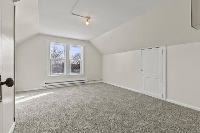 additional living space with vaulted ceiling, a baseboard radiator, and carpet floors