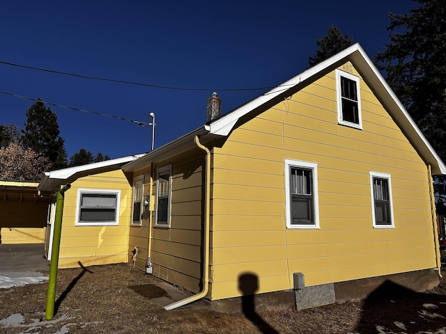 133 Pine Ave, Hill City, SD 57745 - view of home's exterior with a chimney