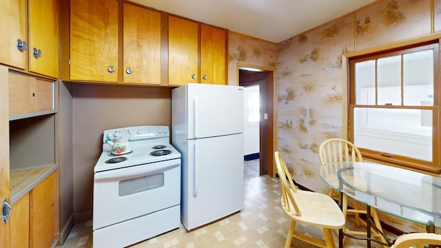 133 Pine Ave, Hill City, SD 57745 - kitchen with white appliances, wallpapered walls, light flooring, and brown cabinetry