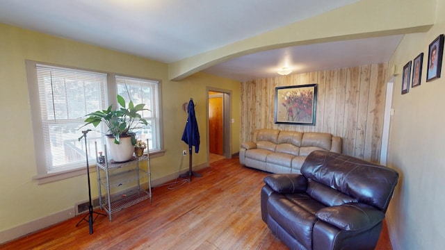 133 Pine Ave, Hill City, SD 57745 - living area with arched walkways, plenty of natural light, wood finished floors, and wooden walls