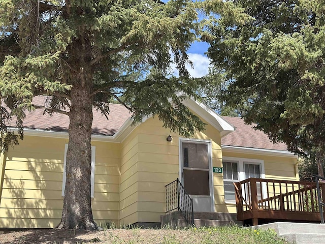 133 Pine Ave, Hill City, SD 57745 - view of front facade featuring a shingled roof and entry steps