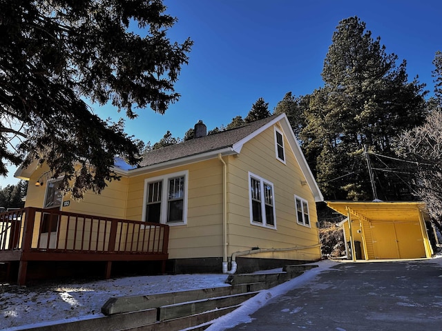 133 Pine Ave, Hill City, SD 57745 - view of side of property with a chimney, a deck, and an outdoor structure