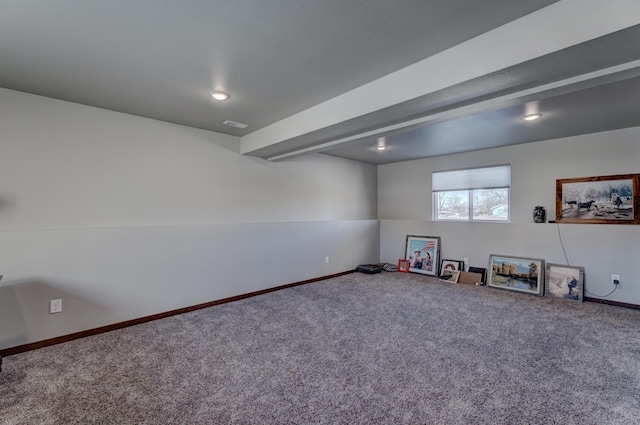 recreation room with beamed ceiling and carpet