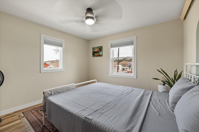 bedroom with wood-type flooring and ceiling fan