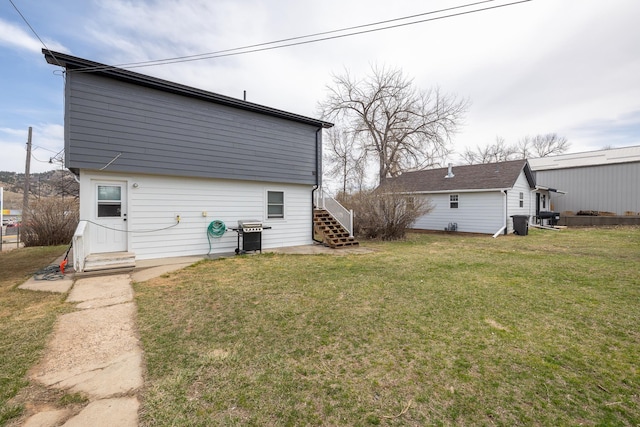 rear view of house featuring a yard