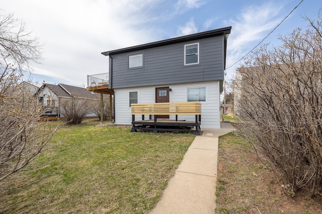 back of house featuring a yard and a deck