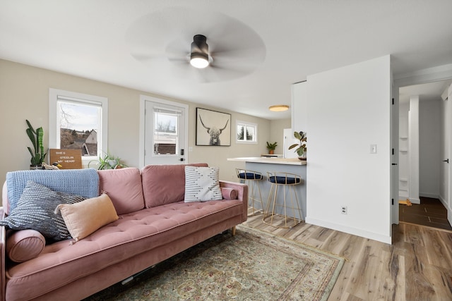 living room with ceiling fan and hardwood / wood-style floors