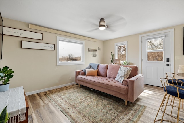 living room featuring ceiling fan and light hardwood / wood-style floors