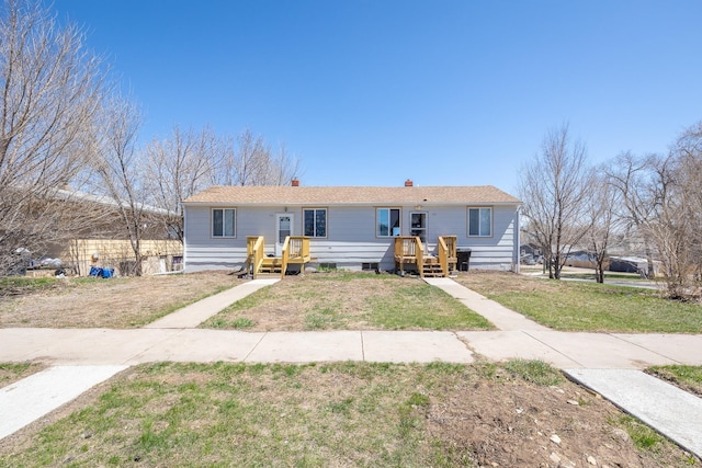 view of front of house with a deck and a front lawn