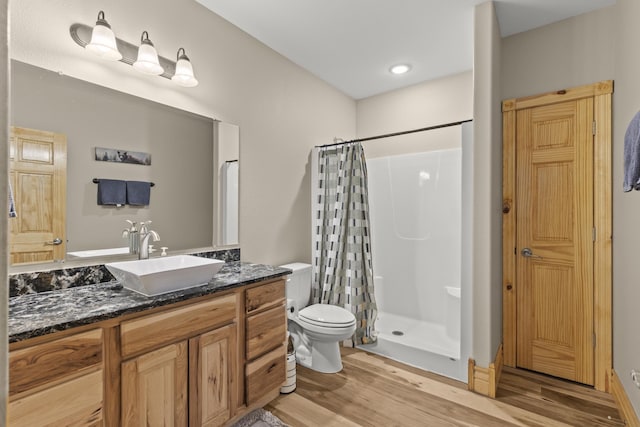 bathroom with vanity, hardwood / wood-style floors, and walk in shower