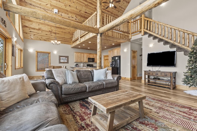 living area with light wood-type flooring, wood ceiling, stairs, and high vaulted ceiling