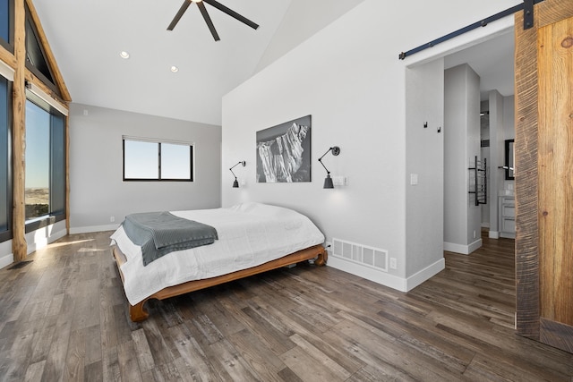 7102 Marvel Mountain Rdg, Rapid City, SD 57702 - bedroom with dark wood-type flooring, high vaulted ceiling, a barn door, and ceiling fan