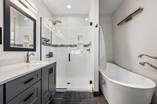 bathroom with tile patterned floors, vanity, and independent shower and bath