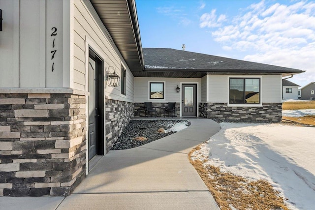 view of snow covered property entrance