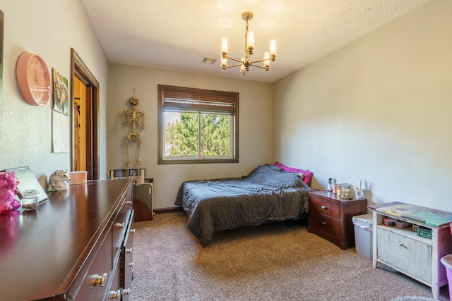 bedroom with a chandelier, light carpet, and a textured ceiling