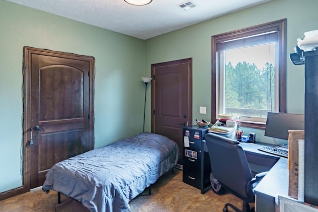 bedroom featuring a textured ceiling