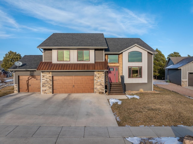 view of front facade featuring concrete driveway, an attached garage, a standing seam roof, metal roof, and stone siding