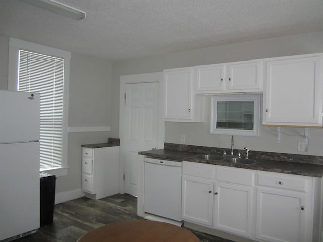 kitchen featuring sink, a textured ceiling, dark hardwood / wood-style floors, white appliances, and white cabinets